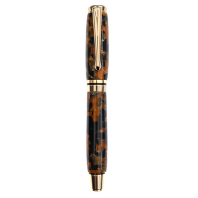 Carbon Caramel handcrafted resin fountain pen made by Wig and Pens. Swirls of brown, orange, black and hints of gold throughout the body of the pen with gold pen clip, tip and hardware. Also available as a ball point pen. Image of the pen with lid on it,