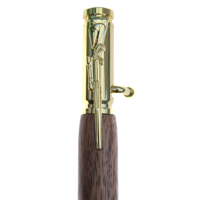 Handcrafted wood and 30 caliber bullet pen by Wig and Pens. A close up image of the pen clip in the shape of a rifle and bolt action.